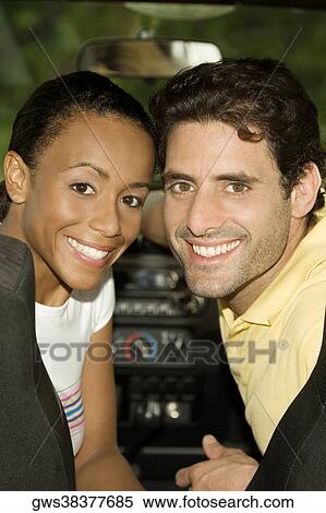 Portrait of a young woman and a mid adult man sitting in a car View Large Photo Image Stock Photography - Portrait of a young woman and a mid adult man sitting in a car. Fotosearch