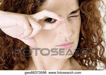 Portrait of a young woman gesturing with her hand View Large Photo Image Stock Photograph - Portrait of a young woman gesturing with her hand. Fotosearch