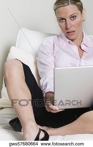 Portrait of a young woman holding a laptop View Large Photo Image Picture - Portrait of a young woman holding a laptop. Fotosearch