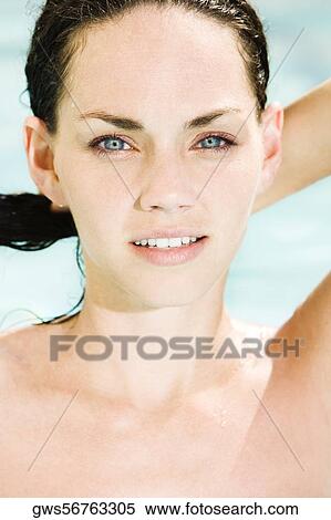 Portrait of a young woman holding her hair View Large Photo Image Stock Photography - Portrait of a young woman holding her hair. Fotosearch