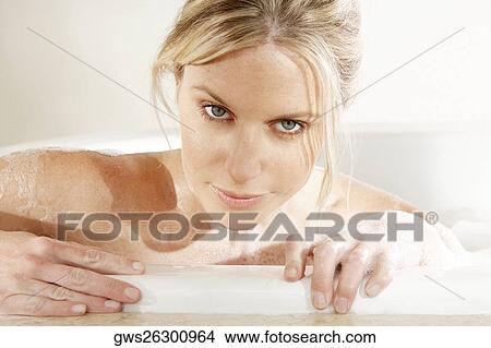 Portrait of a young woman in a bathtub View Large Photo Image Picture - Portrait of a young woman in a bathtub. Fotosearch