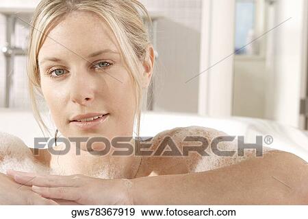 Portrait of a young woman in a bathtub View Large Photo Image Stock Photo - Portrait of a young woman in a bathtub. Fotosearch