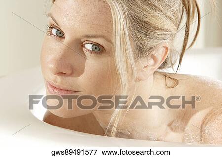 Portrait of a young woman in a bathtub View Large Photo Image Stock Photo - Portrait of a young woman in a bathtub. Fotosearch