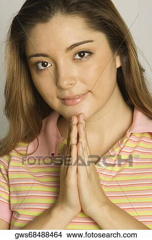 Portrait of a young woman in a prayer position View Large Photo Image Picture - Portrait of a young woman in a prayer position. Fotosearch