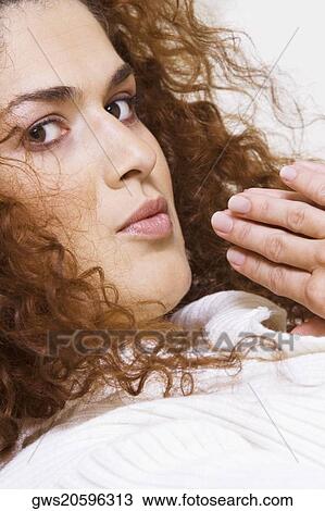 Stock Image - Portrait of a young woman in a prayer position. Fotosearch