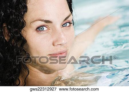 Portrait of a young woman in a swimming pool View Large Photo Image Stock Photo - Portrait of a young woman in a swimming pool. Fotosearch