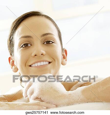 Portrait of a young woman leaning at the edge of a bathtub View Large Photo Image Stock Image - Portrait of a young woman leaning at the edge of a bathtub. Fotosearch