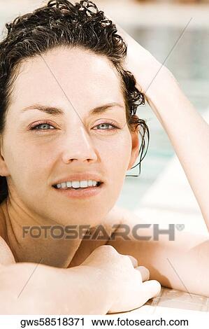 Portrait of a young woman leaning at the edge of a swimming pool View Large Photo Image Stock Image - Portrait of a young woman leaning at the edge of a swimming pool. Fotosearch
