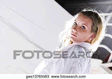 Portrait of a young woman looking serious View Large Photo Image Stock Image - Portrait of a young woman looking serious. Fotosearch