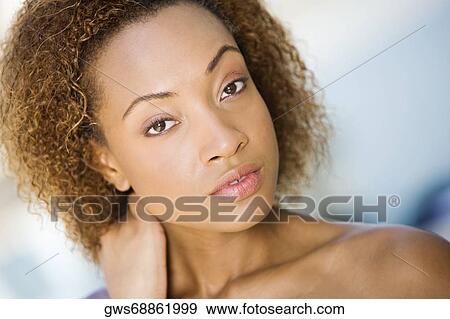 Portrait of a young woman looking serious View Large Photo Image Stock Photo - Portrait of a young woman looking serious. Fotosearch