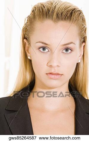 Stock Photo - Portrait of a young woman looking serious. Fotosearch