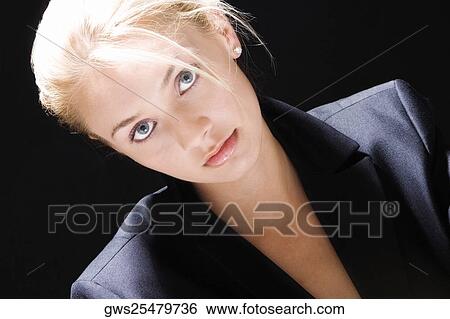 Stock Photograph - Portrait of a young woman looking serious. Fotosearch