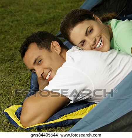 Portrait of a young woman lying on the back of a young man View Large Photo Image Picture - Portrait of a young woman lying on the back of a young man. Fotosearch