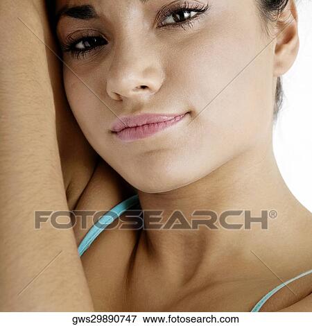 Stock Photo - Portrait of a young woman lying on the bed. Fotosearch