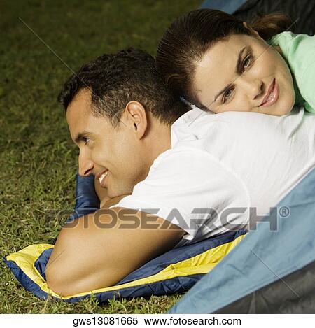 Portrait of a young woman lying on the back of a young man View Large Photo Image Stock Photography - Portrait of a young woman lying on the back of a young man. Fotosearch