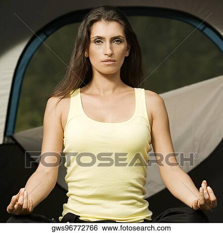 Stock Photograph - Portrait of a young woman meditating. Fotosearch