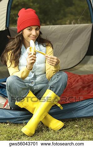 Portrait of a young woman peeling a banana View Large Photo Image Stock Image - Portrait of a young woman peeling a banana. Fotosearch