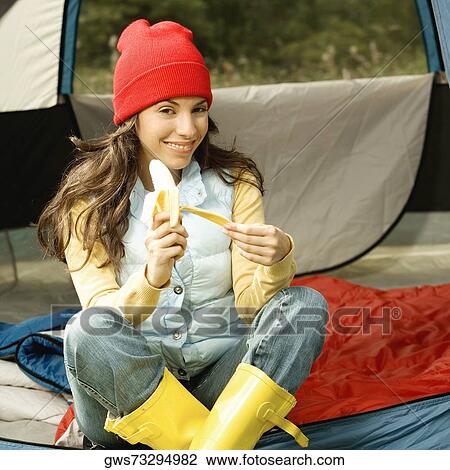 Portrait of a young woman peeling a banana View Large Photo Image Stock Image - Portrait of a young woman peeling a banana. Fotosearch