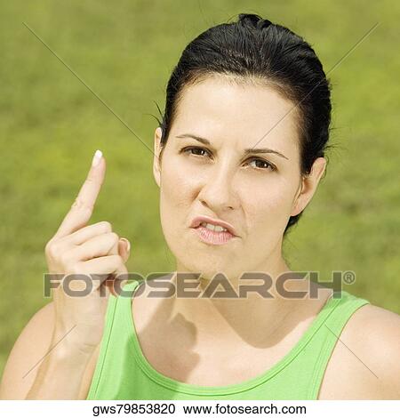 Portrait of a young woman pointing up View Large Photo Image Stock Image - Portrait of a young woman pointing up. Fotosearch