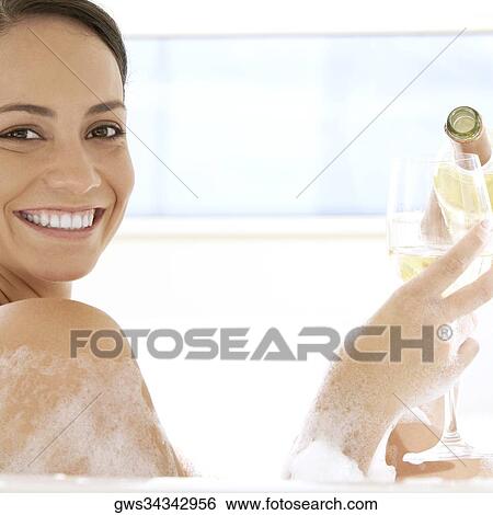 Portrait of a young woman pouring white wine into a wineglass View Large Photo Image Stock Photograph - Portrait of a young woman pouring white wine into a wineglass. Fotosearch