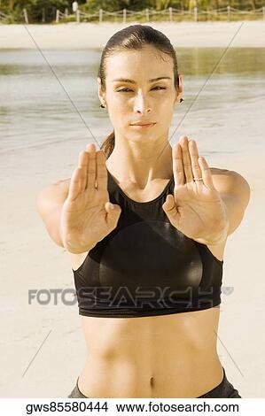 Portrait of a young woman practicing martial arts on the beach View Large Photo Image Picture - Portrait of a young woman practicing martial arts on the beach. Fotosearch