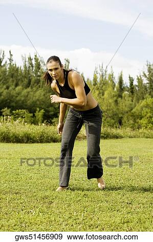 Portrait of a young woman practicing martial arts View Large Photo Image Stock Photo - Portrait of a young woman practicing martial arts. Fotosearch