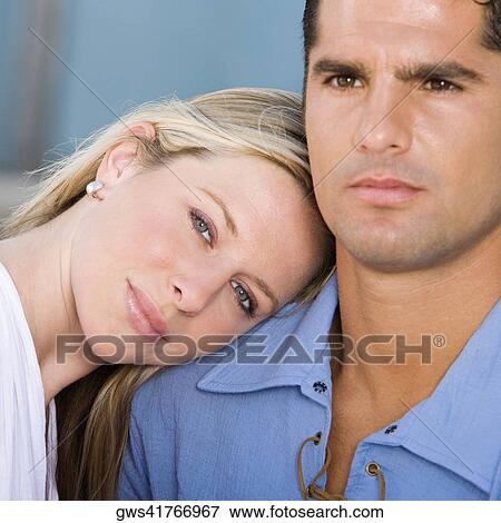Portrait of a young woman resting her head on a mid adult man's shoulder View Large Photo Image Stock Photo - Portrait of a young woman resting her head on a mid adult man's shoulder. Fotosearch