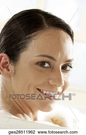 Portrait of a young woman sitting in the bathtub View Large Photo Image Stock Image - Portrait of a young woman sitting in the bathtub. Fotosearch