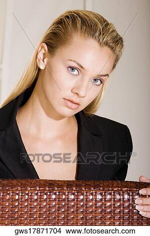Portrait of a young woman sitting on a chair View Large Photo Image Picture - Portrait of a young woman sitting on a chair. Fotosearch
