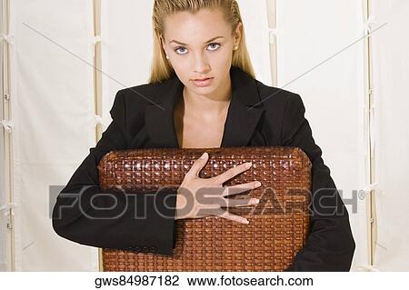 Portrait of a young woman sitting on a chair View Large Photo Image Stock Image - Portrait of a young woman sitting on a chair. Fotosearch