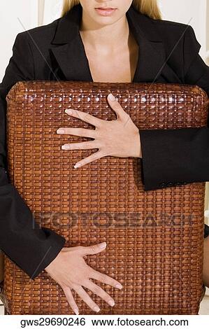 Portrait of a young woman sitting on a chair View Large Photo Image Stock Photograph - Portrait of a young woman sitting on a chair. Fotosearch