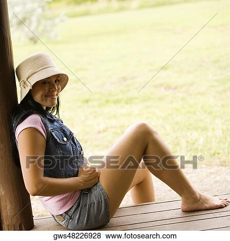 Portrait of a young woman smiling on the porch View Large Photo Image Stock Photo - Portrait of a young woman smiling on the porch. Fotosearch