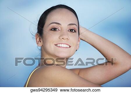 Portrait of a young woman smiling View Large Photo Image Stock Photo - Portrait of a young woman smiling. Fotosearch