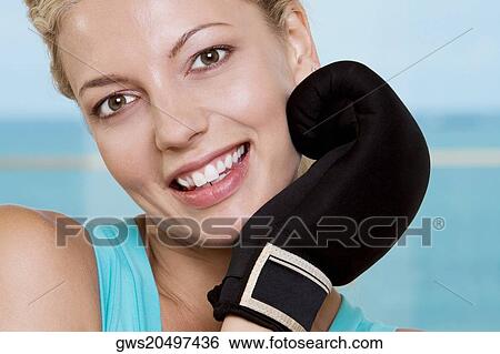 Portrait of a young woman smiling View Large Photo Image Stock Photograph - Portrait of a young woman smiling. Fotosearch