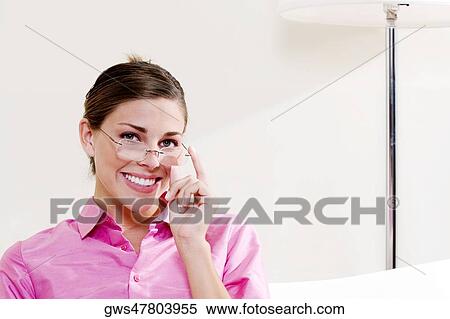 Portrait of a young woman smiling View Large Photo Image Stock Photography - Portrait of a young woman smiling. Fotosearch