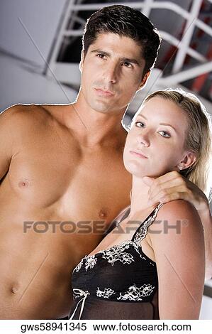 Portrait of a young woman standing with a mid adult man View Large Photo Image Stock Photography - Portrait of a young woman standing with a mid adult man. Fotosearch