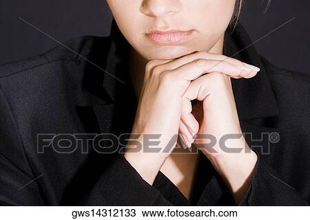 Portrait of a young woman thinking with her hands on her chin View Large Photo Image Stock Image - Portrait of a young woman thinking with her hands on her chin. Fotosearch