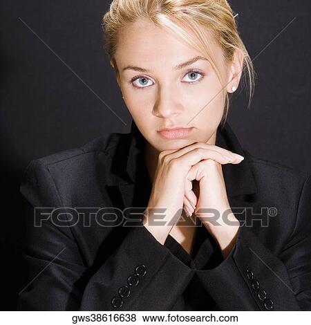 Portrait of a young woman thinking with her hands on her chin View Large Photo Image Stock Photo - Portrait of a young woman thinking with her hands on her chin. Fotosearch