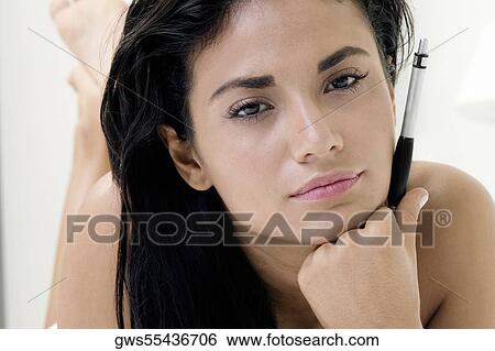 Portrait of a young woman thinking with her hand on her chin View Large Photo Image Stock Photograph - Portrait of a young woman thinking with her hand on her chin. Fotosearch