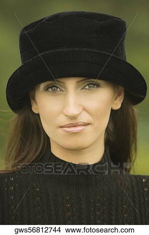 Portrait of a young woman wearing a hat View Large Photo Image Picture - Portrait of a young woman wearing a hat. Fotosearch