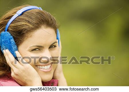 Portrait of a young woman wearing earmuffs View Large Photo Image Stock Image - Portrait of a young woman wearing earmuffs. Fotosearch