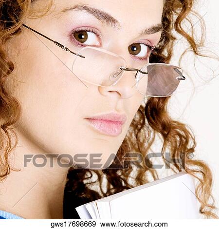Portrait of a young woman wearing eyeglasses View Large Photo Image Stock Photo - Portrait of a young woman wearing eyeglasses. Fotosearch