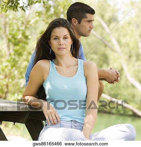 Portrait of a young woman with a mid adult man standing behind her View Large Photo Image Stock Photograph - Portrait of a young woman with a mid adult man standing behind her. Fotosearch