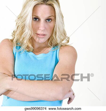 Picture - Portrait of a young woman with her arms crossed. Fotosearch