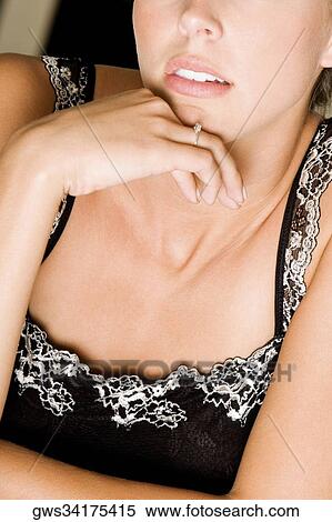 Portrait of a young woman with her hand on her chin View Large Photo Image Stock Photography - Portrait of a young woman with her hand on her chin. Fotosearch
