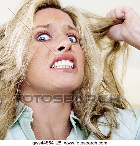Portrait of a young woman with her hand in her hair View Large Photo Image Stock Photography - Portrait of a young woman with her hand in her hair. Fotosearch