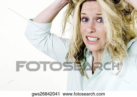 Portrait of a young woman with her hands in her hair View Large Photo Image Stock Image - Portrait of a young woman with her hands in her hair. Fotosearch