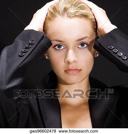 Portrait of a young woman with her hands on her head View Large Photo Image Stock Photo - Portrait of a young woman with her hands on her head. Fotosearch