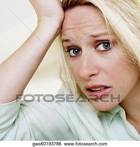 Portrait of a young woman with her hands on her head View Large Photo Image Stock Photograph - Portrait of a young woman with her hands on her head. Fotosearch