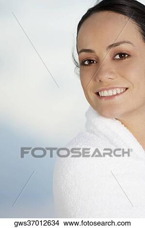 Portrait of a young woman wrapped in a towel View Large Photo Image Picture - Portrait of a young woman wrapped in a towel. Fotosearch